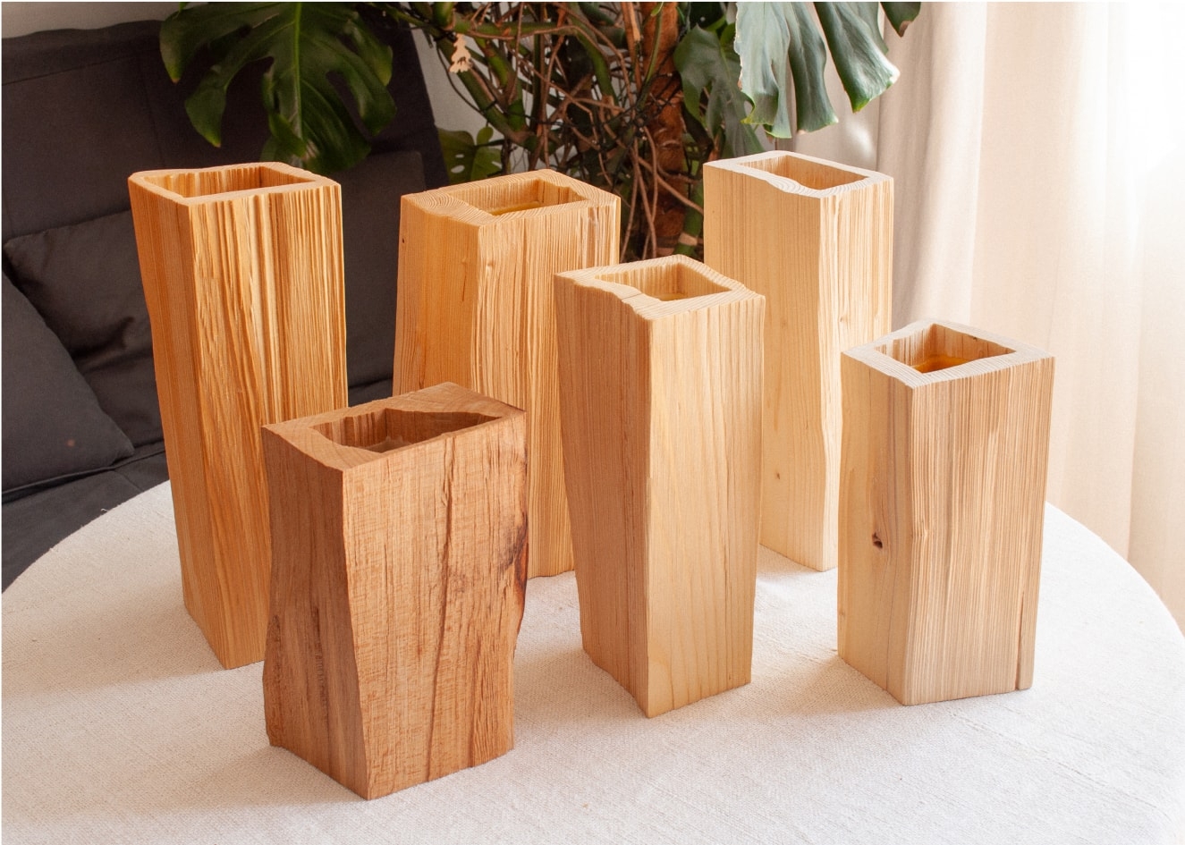 Four wooden vases on table